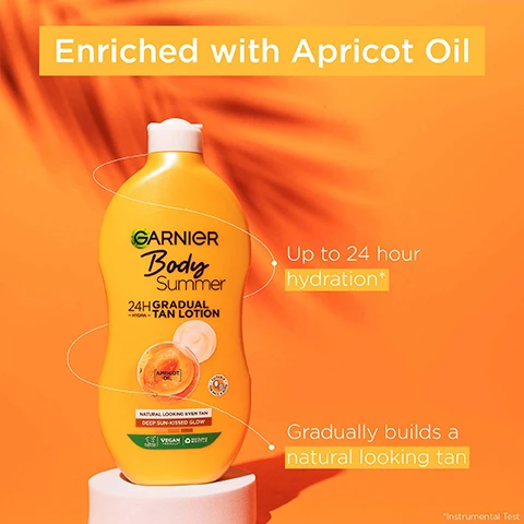 Image 1 - A yellow bottle of Garnier Body Summer 24H Gradual Tan Lotion is placed on a white pedestal with an orange background, featuring text that states Enriched with Apricot Oil, Up to 24 hour hydration*, and Gradually builds a natural looking tan.
Image 2 - Image of a Garnier Body Summer gradual tan lotion bottle with a bright orange background, featuring text that states Dermatologically Tested, Skin looks radiant & intensely nourished, Fast absorption, and Vegan formula.
Image 3 - A bottle of Garnier tanning lotion with a bright yellow label is positioned against an orange background, showing the text No streaks and Deep sun-kissed glow.