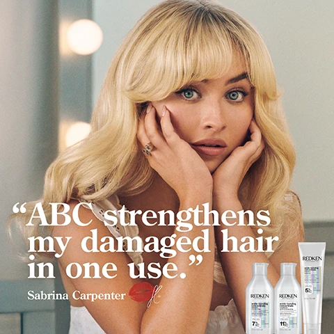 Image 1 - A woman with long, wavy blonde hair rests her face in her hands, looking directly at the viewer with a neutral expression, accompanied by the text ABC strengthens my damaged hair in one use, Sabrina Carpenter and three Redken hair care product bottles.
Image 2 - A bottle of Redken Acidic Bonding Concentrate Shampoo is shown with a foamy texture surrounding it, and the image includes the text 56% less breakage, 11x smoother, silky finish & glossy shine.
Image 3 - Image shows two side-by-side comparisons of hair: the left side labeled BEFORE depicts frizzy, uneven blonde hair, and the right side labeled AFTER ONE USE* shows sleek, smooth, straight hair with a healthier appearance; visible text includes *SYSTEM OF ACIDIC BONDING CONCENTRATE INTENSIVE TREATMENT, SHAMPOO, CONDITIONER & LEAVE-IN VS. UNDAMAGED HAIR.
Image 4 - A person with curly hair is shown from the back, displaying two sections labeled BEFORE on the left side with frizzy hair and AFTER ONE USE* on the right side with defined, shiny curls, along with visible text at the bottom that reads SYSTEM OF ACIDIC BONDING CONCENTRATE INTENSIVE TREATMENT, SHAMPOO, CONDITIONER & LEAVE IN VS. UNDAMAGED HAIR.
Image 5 - An image featuring white creamy textures with visible bubbles, accompanied by text that reads CITRIC ACID + BONDING CARE COMPLEX HELPS REPAIR BONDS + PREVENT FUTURE DAMAGE.
Image 6 - A display of three hair care products from Redken for damage repair, including a shampoo, conditioner, and leave-in treatment, with visible text indicating DAMAGE REPAIR FOR CHEMICALLY TREATED HAIR, SHAMPOO 1, CONDITION 2, and PROTECT & LEAVE-IN 3.