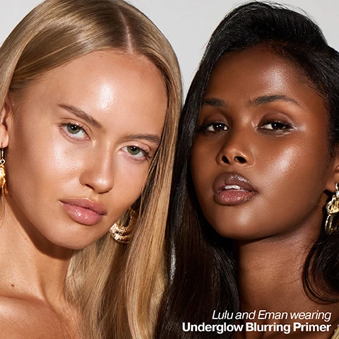 Image 2 - A close-up of two women, Lulu with blonde hair and fair skin and Eman with dark hair and dark skin, looking directly at the viewer with radiant, smooth complexions, with the text Lulu and Eman wearing Underglow Blurring Primer. Image 3 - A shimmery, light peach or champagne-colored cosmetic liquid is swiped across a surface, with visible text that reads Underglow Blurring Primer Primes, preps, minimises the appearance of pores. Image 4 - A golden liquid drips from a dropper into an Iconic London Underglow Blurring Primer bottle, alongside text describing key ingredients: Vitamin C, This antioxidant helps fight free radicals to prevent aging and boost radiance; Artemisia Capillaris, Japanese plant extract helps to protect against Blue HEV Light; and Soft Focus Blurring Powders, Gives a soft touch and blurs light to reduce the look of fine lines. Image 5 - A close-up image shows a person with dark skin applying a drop of light serum or moisturizer near their eye with a finger that has a long pink and white manicured nail, alongside the text how to use Shake the bottle well and apply 2-3 drops all over the face, focusing on any areas that are often prone to excess shine. Image 6 - Several beige-colored drops and smears of liquid product are scattered on a white background, accompanied by text bubbles stating: help your makeup last longer, even skin tone and blur imperfections, skin feels instantly hydrated, doesn’t block pores or feel greasy or sticky, and Use alone for an effortless no-makeup makeup look. Image 7 - A split image of a womans face demonstrating two different primer effects: the left half shows visible pores with text VELVET SMOOTH PORE-REFINING PRIMER, and the right half shows smoother, luminous skin with text UNDERGLOW BLURRING PRIMER. Image 8 - A close-up image of a womans face with glowing skin, showing her right eye, nose, and mouth, next to three customer reviews reading: Love this underglow primer, gives perfect smooth base - Kelly; My favourite primer it is the best feels amazing on the skin on no makeup days still like to have this on for a little glow - Laura; Absolutely in love with this primer so easy to apply and skin feels so clear and soft - Anne.