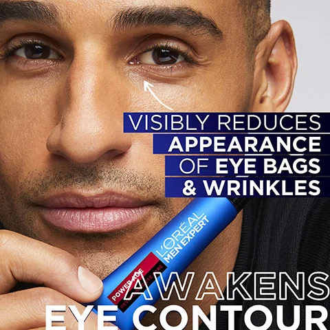 A close-up image shows a mans face with an arrow pointing to his under-eye area, accompanied by the text Visibly Reduces Appearance of Eye Bags & Wrinkles, while he holds a blue LOreal Men Expert tube that also displays Power Age Revitalizing 24H Moisture and Awakens Eye Contour.