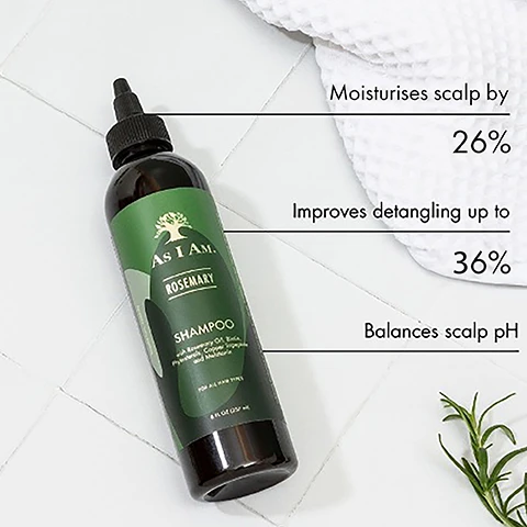 Image 1 - A bottle of As I Am Rosemary Shampoo is placed on a white tiled surface with visible text highlighting benefits: moisturises scalp by 26%, improves detangling up to 36%, and balances scalp pH.
Image 2 - A bottle of As I Am Rosemary shampoo is displayed on light green steps, accompanied by symbols and text indicating it is vegan and cruelty-free, sulfate-free, and has a natural fragrance.