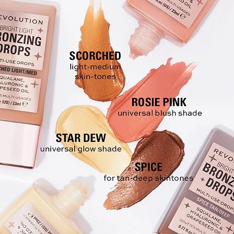 Image shows four shades of bronzing drops laid out with corresponding product labels: a bottle labeled Bright Light Bronzing Drops from Revolution along with swatches of four shades labeled Scorched, Star Dew, Rosie Pink, and Spice, each with descriptions of their intended skin tones.