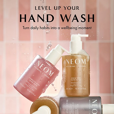 Image 1 - Image shows three bottles of NEOM hand wash in front of a pink tiled background, featuring labels that read COMPLETE BLISS HAND WASH, GREAT DAY HAND WASH, and REAL LUXURY HAND WASH, with splashes of water around them and the text LEVEL UP YOUR HAND WASH Turn daily habits into a wellbeing moment.
Image 2 - A bottle of NEOM Real Luxury Hand Wash is shown against a pink background, with visible text detailing its ingredients and benefits: for a touch of real luxury, lavender, jasmine and sandalwood, blended with hydrating marine extract and coconut water, natural colour derived from gardenia fruit.
Image 3 - Two NEOM wellbeing bottles, one containing hand wash and the other hand lotion, are placed on a soft pink background with water droplets on them, along with text stating 100% recyclable bottle designed to be refilled and reused and 100% natural fragrances that turn everyday moments into a wellbeing experience.
Image 4 - A hand is holding a bottle of NEOM Wellbeing London with liquid pouring out, and text reads 84% said the fragrance left them feeling INSTANTLY DE-STRESSED*.