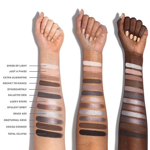 Image 1 - Three arms with swatches of different shades of makeup on their forearms, labeled with names including Speed of Light, Just a Phase, Extra Alienating, Rocket to Riches, Otherearthly, Galactic Gem, Lucky Stars, Opulent Orbit, Space Age, Nocturnal Nova, Cocoa Cosmos, and Total Eclipse.
Image 2 - A grid of twelve eyeshadow shades arranged in four rows, featuring various colors and textures with numbers 01 to 12 indicating each shade, labeled with names such as Speed of Light, Just a Phase, and Cocoa Cosmos.
Image 3 - A close-up of an eye showcasing a dramatic makeup look with blended shades of silver and black eyeshadow, complemented by long eyelashes, with a palette of eyeshadow colors labeled 03, 04, 07, 08, and 12 shown below.
Image 4 - Close-up image of a womans eye with smoky eyeshadow and long eyelashes, featuring a color palette beneath showing shades labeled 01, 04, and 05.
Image 5 - An image featuring three eye shadow pigments in shades of brown and pink, accompanied by text describing the features of a product: THE POWER OF CHROMAPLUS BLEND, PIGMENT-PACKED PERFORMANCE, ALL-DAY, CREASEPROOF WEAR, and LUXURIOUS BLENDABILITY & BUILDABILITY.
Image 6 - An image of three open eyeshadow palettes displayed at an angle, showcasing various colored shades inside, with text that reads INFINITE BUT COMPACT CURATIONS, NEXT-GEN FORMATS Choose from 6- or 12-pan palettes—designed for any mood and every moment, ENDLESS EXPRESSION Build versatile looks with timeless and trending shades, and READY WHEN YOU ARE Apply on the go with a built-in mirror.
Image 7 - An image showing three categories of cosmetic finishes with close-up textures: Seamless Mattes with a smooth pink background and text describing them as smooth and ultrablendable; Luminous Shimmers featuring a sparkling pink surface and text describing them as silky and radiant; High-Shine Metallics with a glittery pink texture and text stating they are creamy and high-impact.