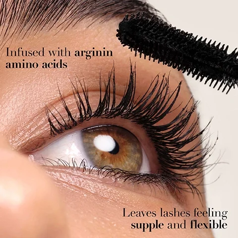 Image 3 - A close-up of an eye with long, dark lashes, as a mascara wand applies product to them, with the text Infused with arginin amino acids and Leaves lashes feeling supple and flexible.